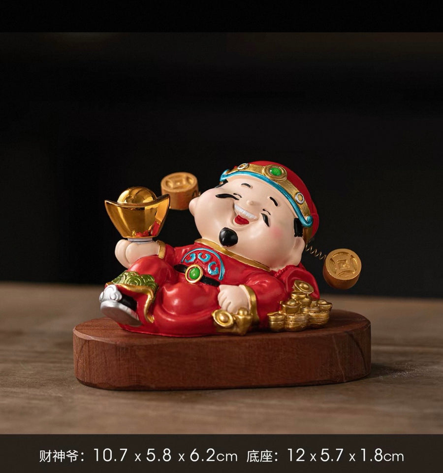Reclining Caishen tabletop ornament on wooden base